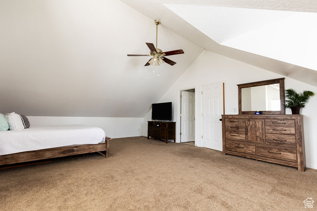 Bedroom featuring lofted ceiling, light colored carpet, and ceiling fan