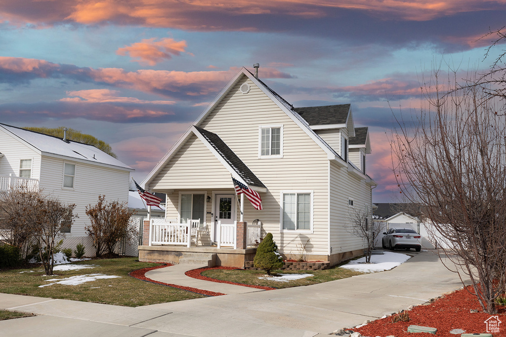 View of front of house with covered porch and concrete driveway