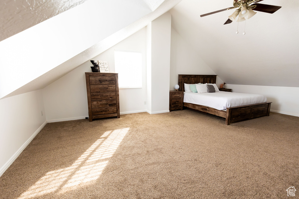 Unfurnished bedroom featuring baseboards, carpet floors, and lofted ceiling