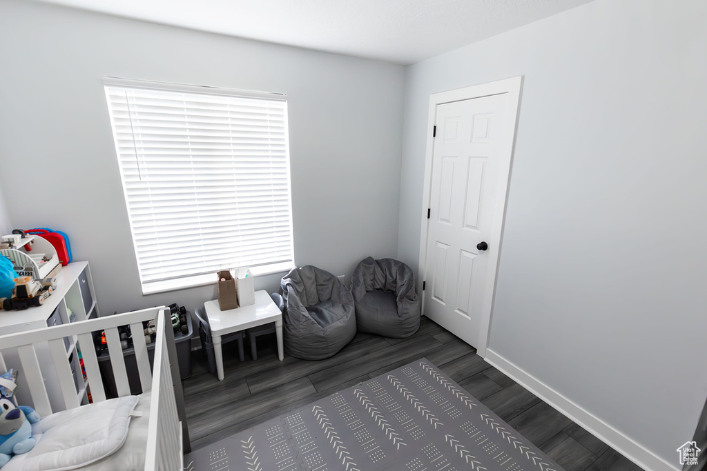 Bedroom with baseboards and wood finished floors