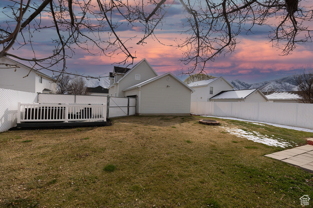 View of yard featuring a fire pit and a fenced backyard