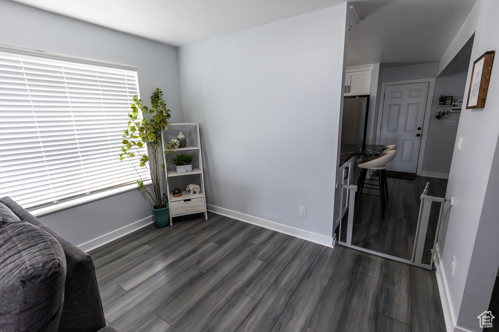 Sitting room with dark wood-style floors and baseboards