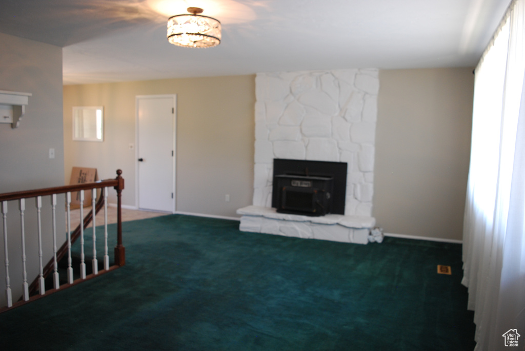 Unfurnished living room with carpet and healthy amount of natural light