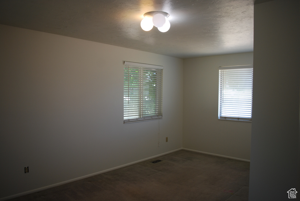 Unfurnished room featuring baseboards