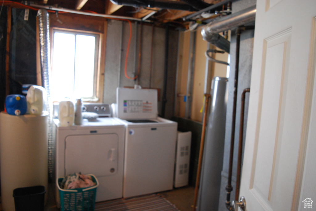 Laundry area featuring separate washer and dryer and laundry area