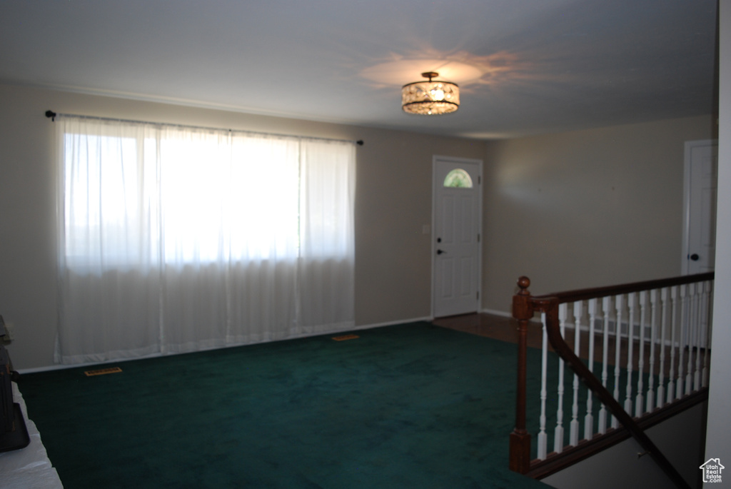 Carpeted entrance foyer with healthy amount of natural light