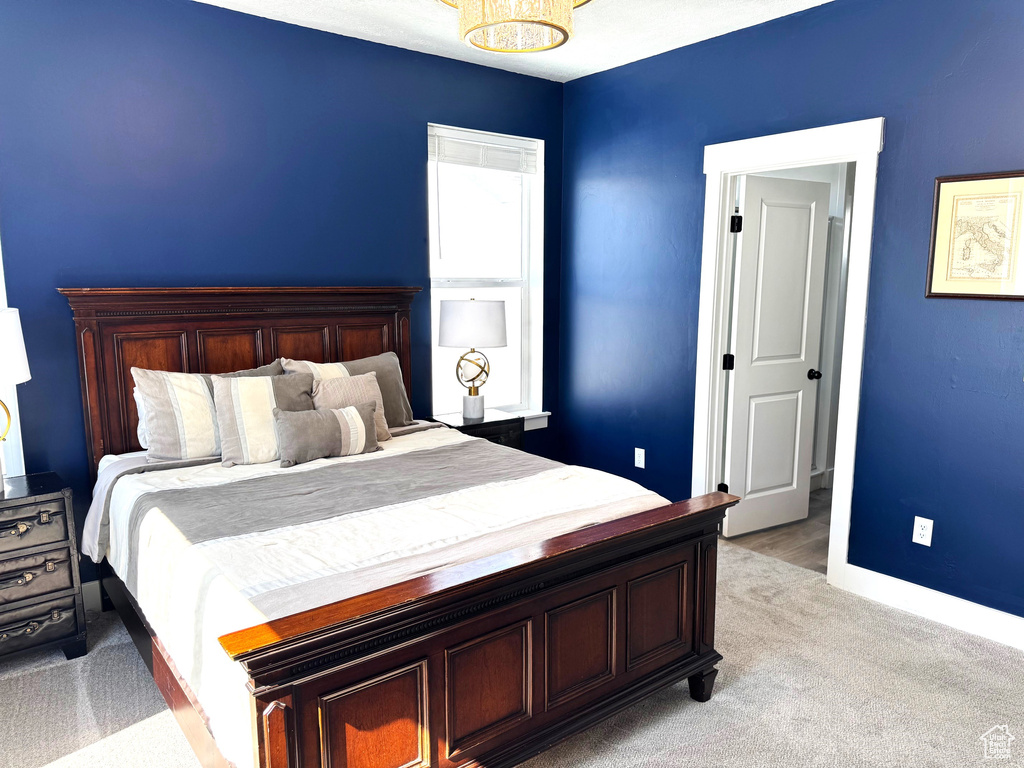 Bedroom featuring baseboards and light carpet