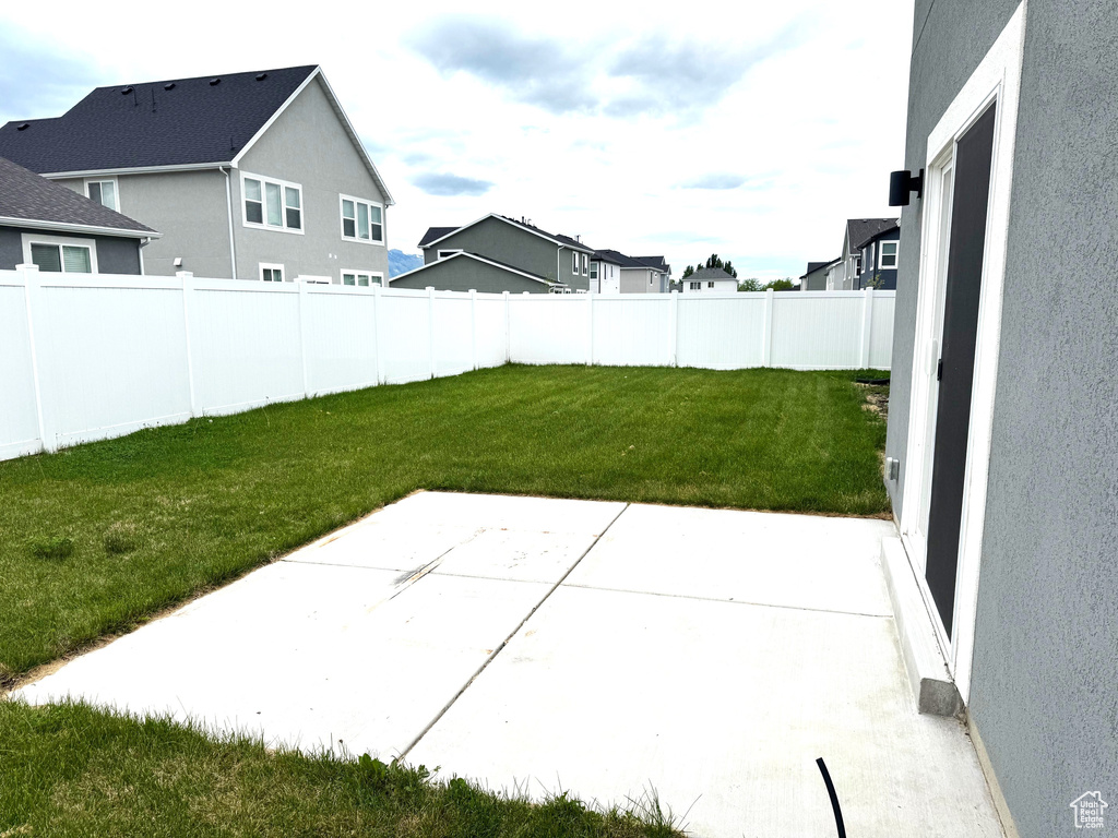 View of yard with a patio and a residential view