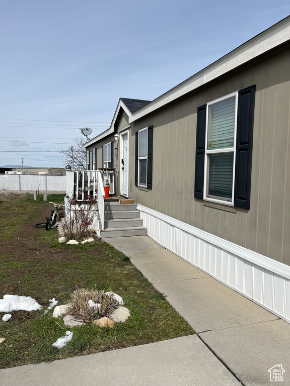 View of side of property featuring a wooden deck