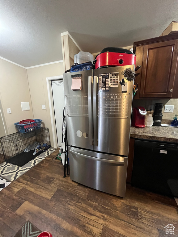 Kitchen featuring dark wood-type flooring, black dishwasher, freestanding refrigerator, dark brown cabinetry, and crown molding
