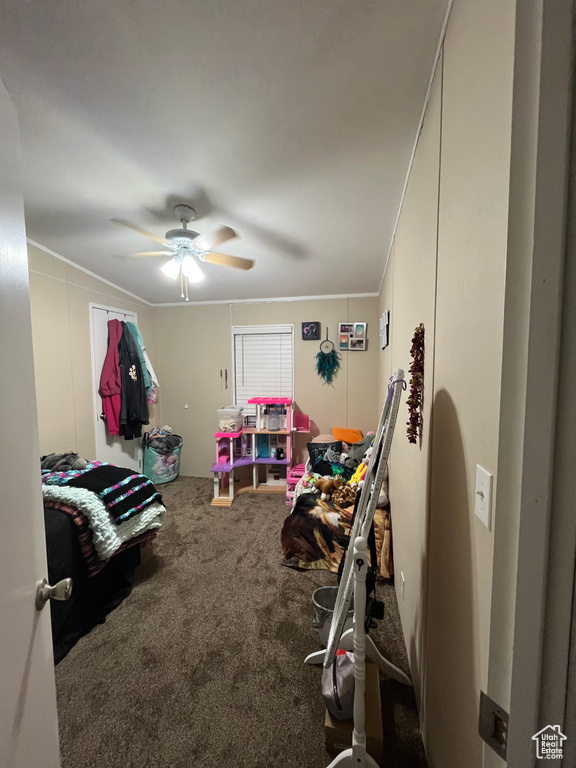Rec room with carpet, ceiling fan, and crown molding
