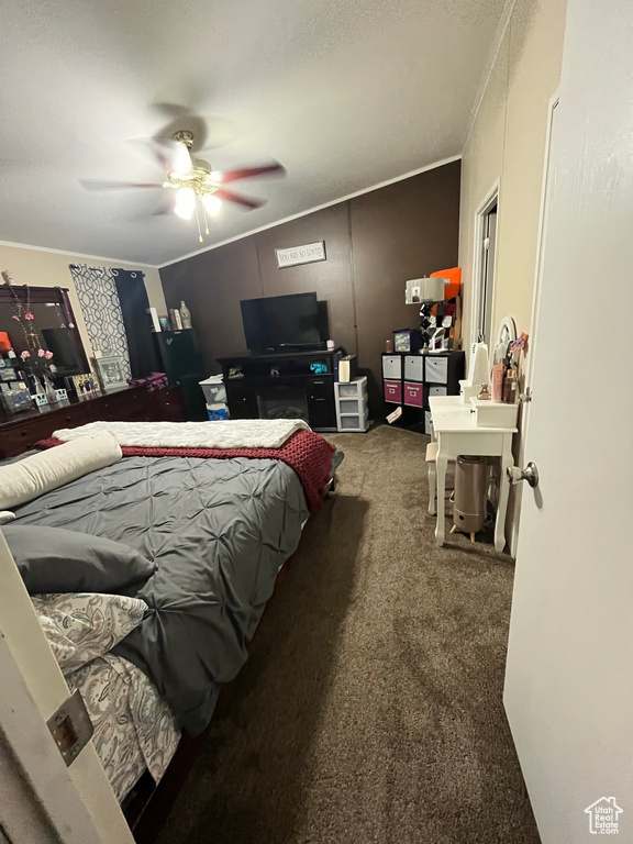 Carpeted bedroom featuring crown molding and ceiling fan