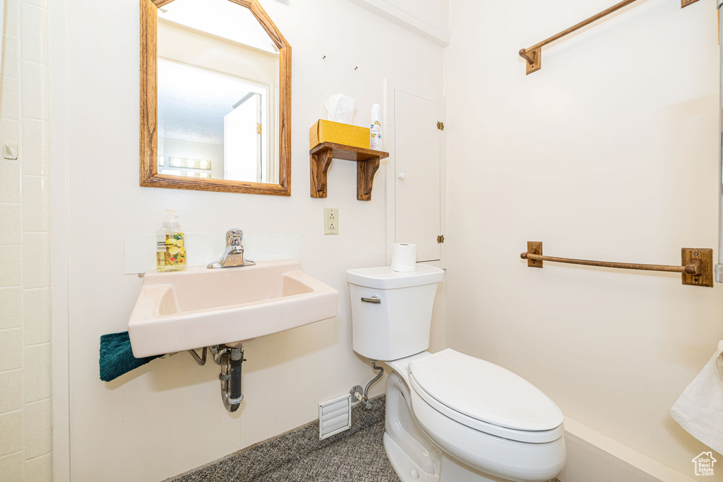 Bathroom featuring toilet and a sink