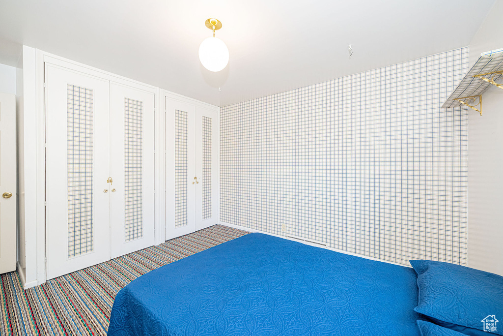 Carpeted bedroom featuring french doors