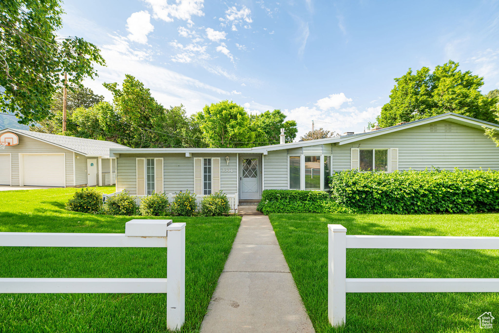 Ranch-style home with a garage and a front yard
