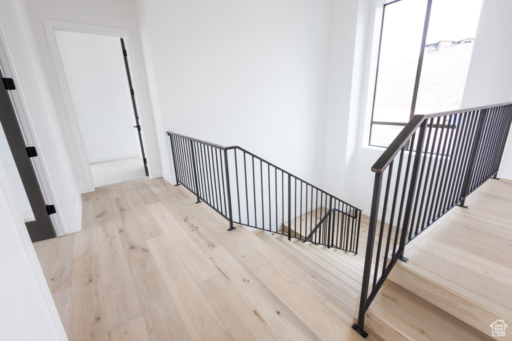 Stairway featuring wood-type flooring