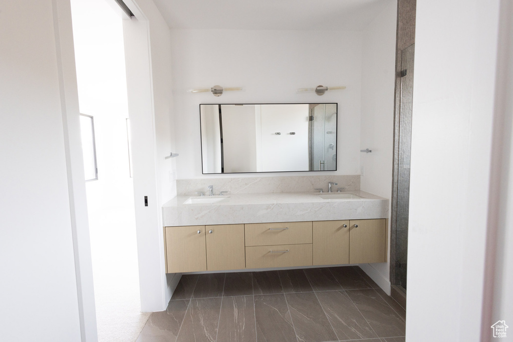 Bathroom with a sink, double vanity, and marble finish floor