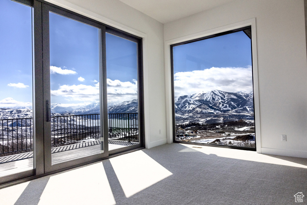 Empty room featuring carpet flooring and a mountain view