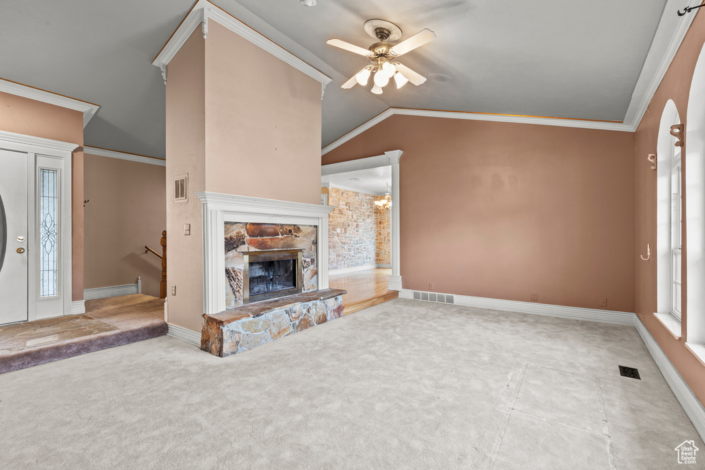 Unfurnished living room featuring visible vents, carpet, ceiling fan, and vaulted ceiling