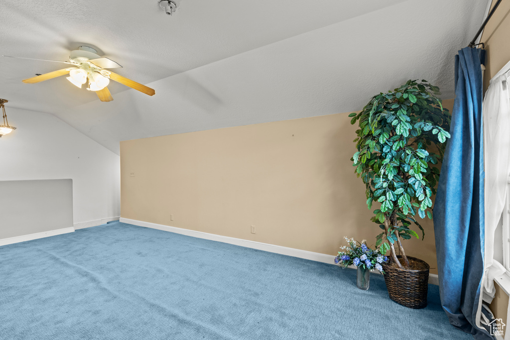 Additional living space with baseboards, ceiling fan, carpet, and lofted ceiling