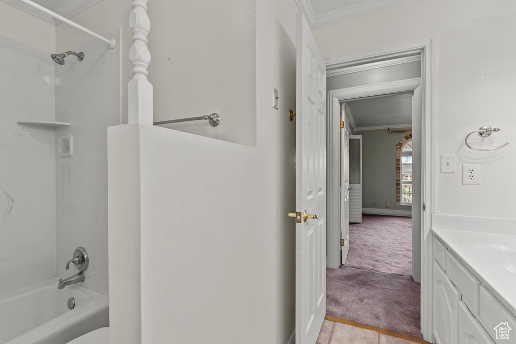 Bathroom with shower / tub combination, ornamental molding, and vanity