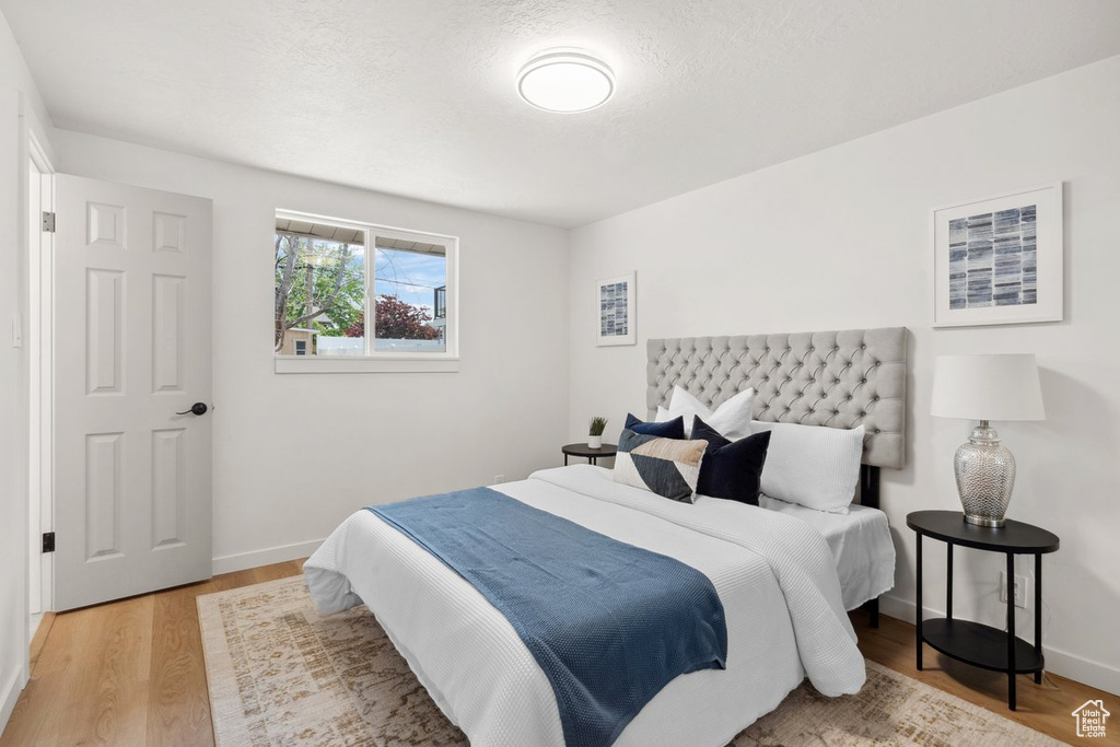 Bedroom featuring light wood finished floors and baseboards