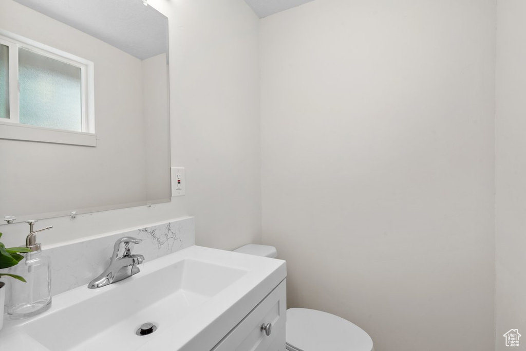 Bathroom featuring vanity and toilet