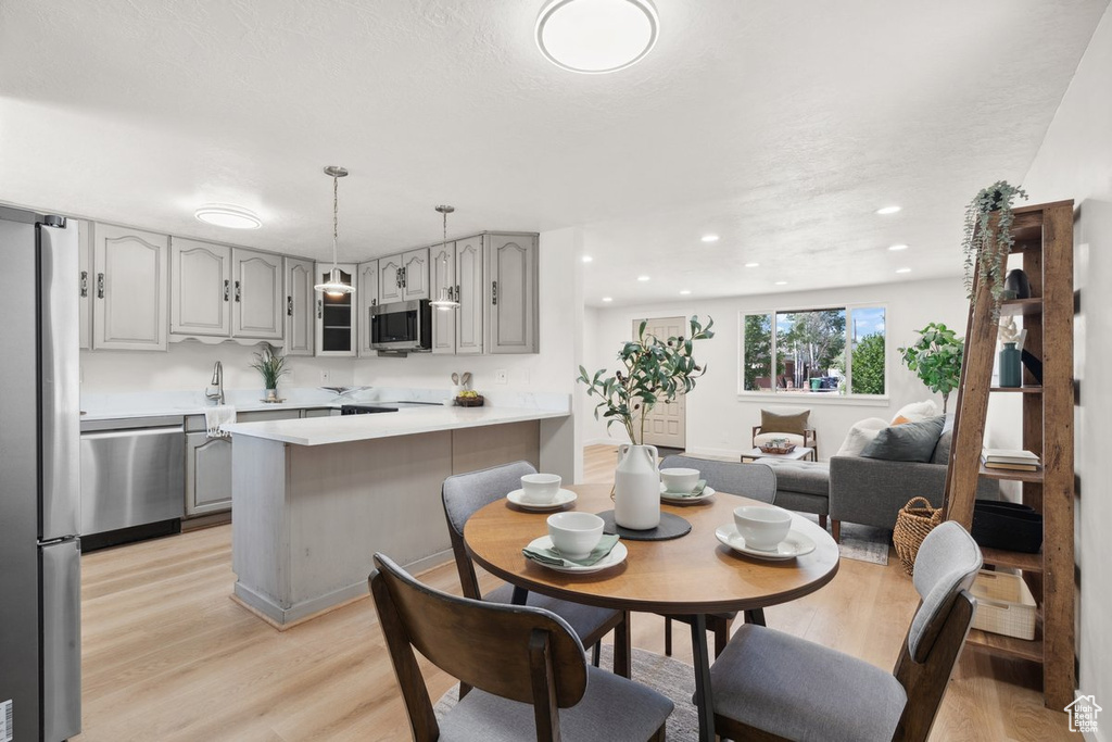 Dining area featuring light wood-type flooring and recessed lighting