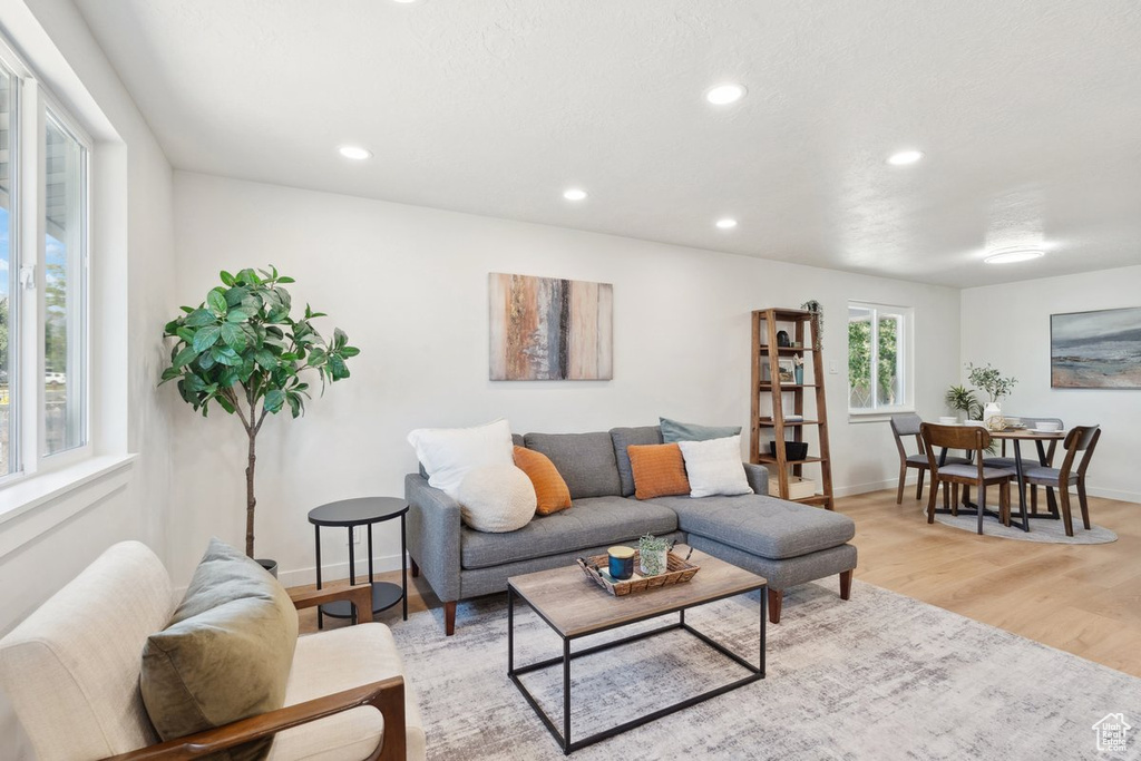 Living area with light wood-style floors, recessed lighting, and baseboards