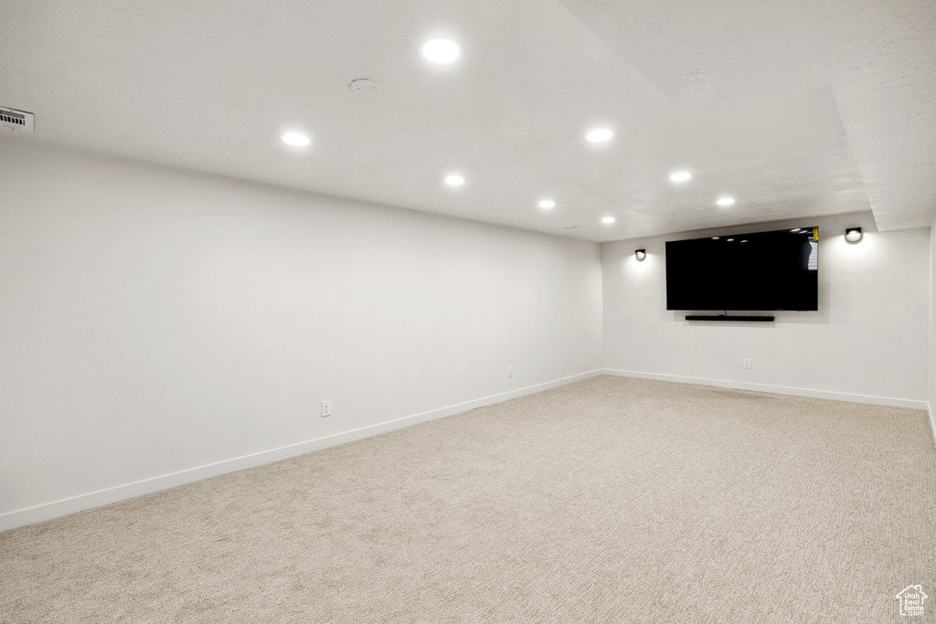 Finished basement featuring recessed lighting, light carpet, and baseboards