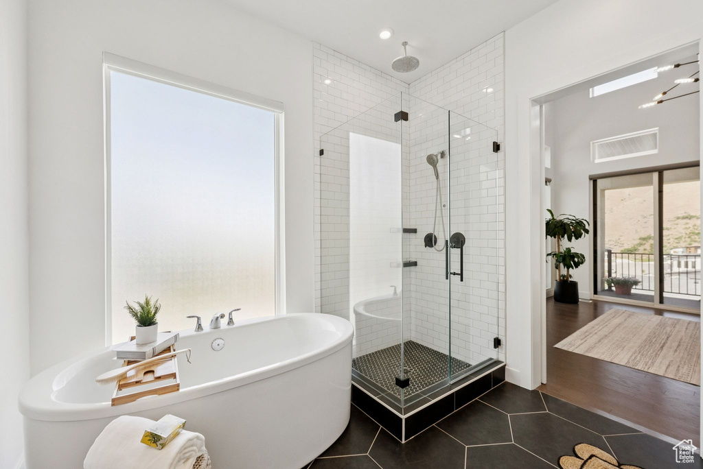 Bathroom with a shower stall, a freestanding bath, tile patterned flooring, and recessed lighting