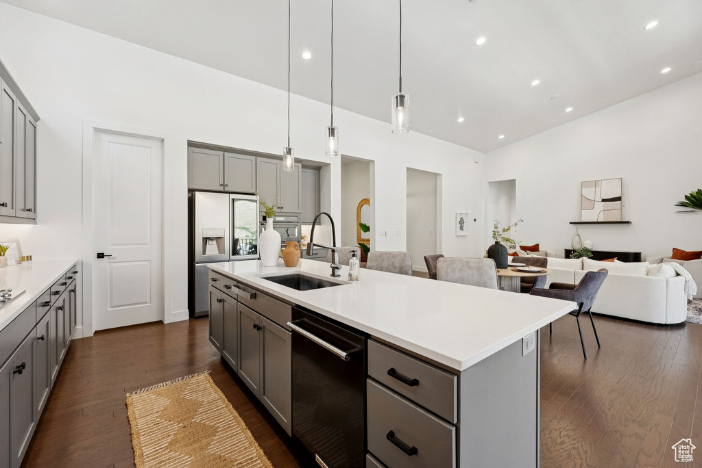 Kitchen with gray cabinets, a sink, dishwasher, and recessed lighting
