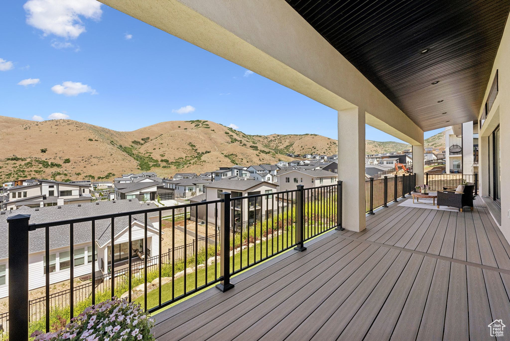 Wooden deck featuring a residential view and a mountain view