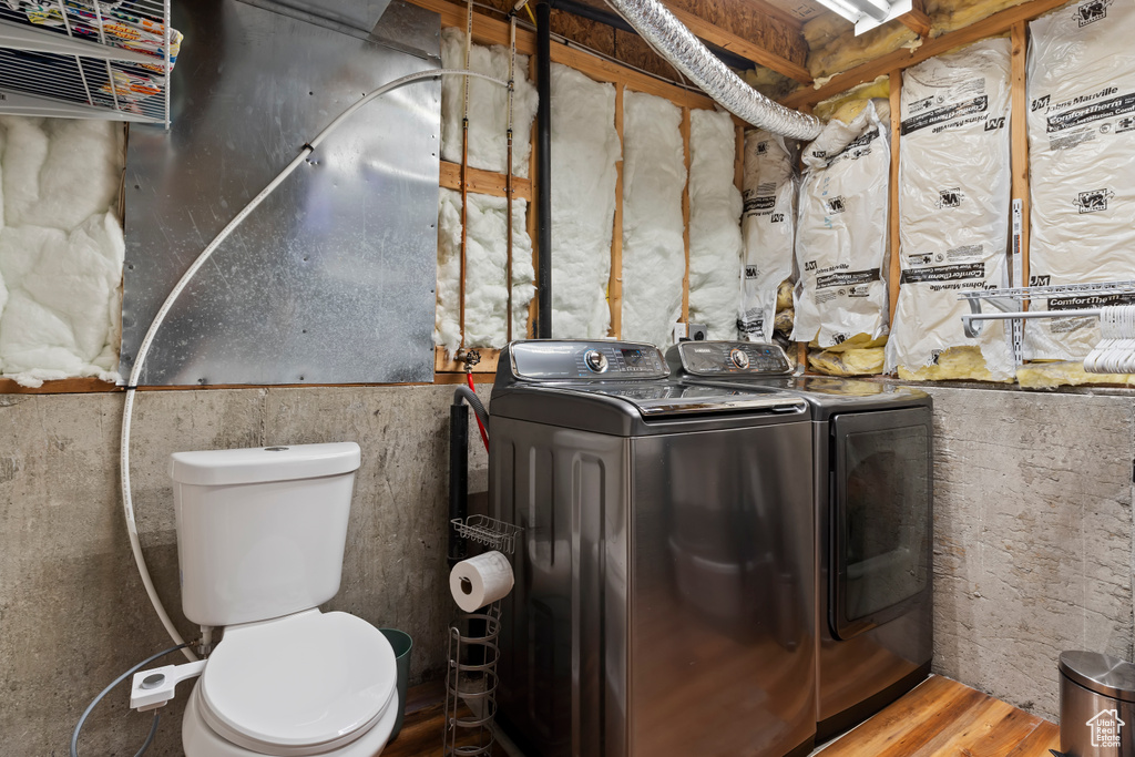 Interior space featuring wood finished floors, laundry area, and washer and dryer