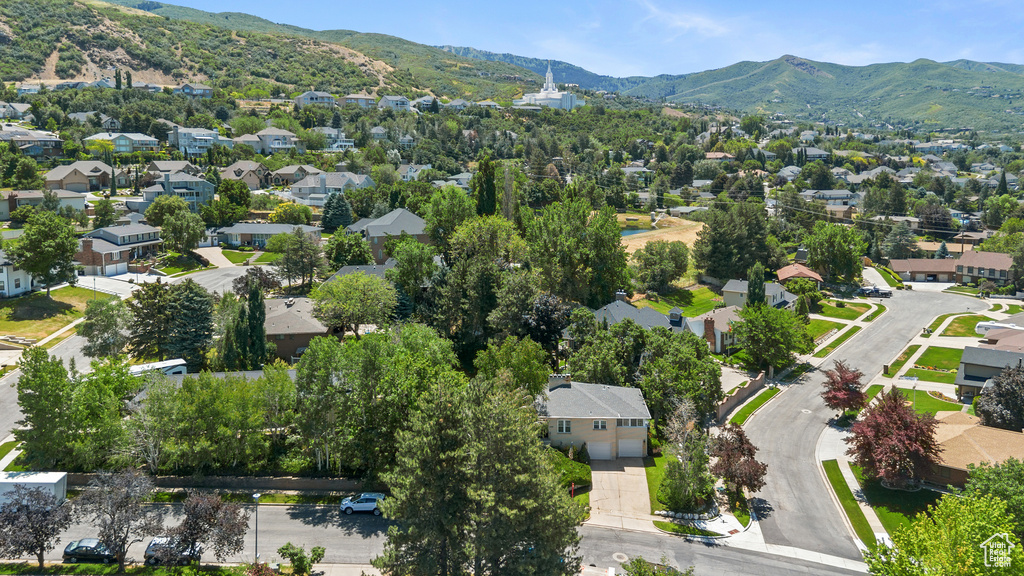 Aerial perspective of suburban area featuring a mountain backdrop