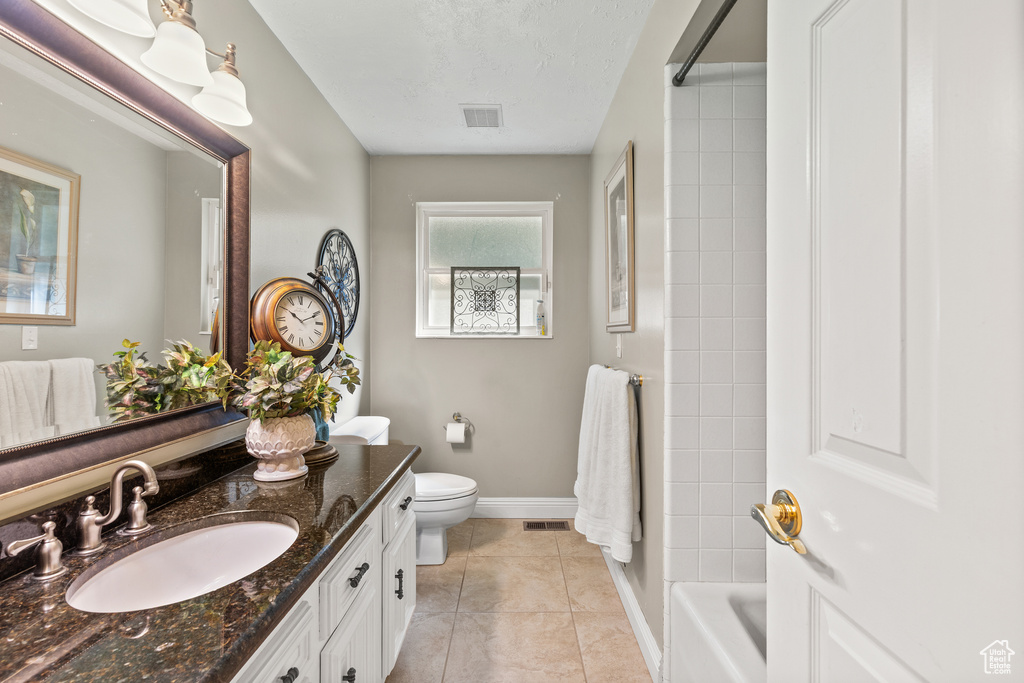 Full bathroom featuring vanity, bathing tub / shower combination, and tile patterned flooring