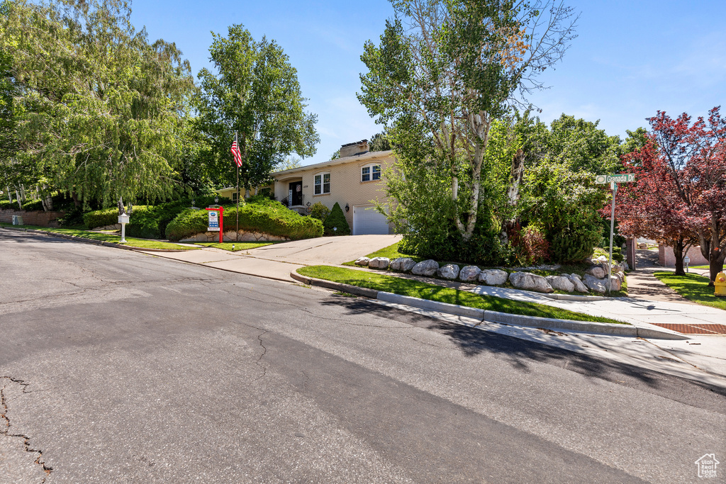View of front of property featuring concrete driveway and an attached garage