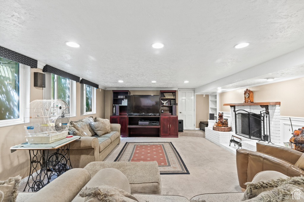 Living room with recessed lighting, a brick fireplace, and carpet flooring