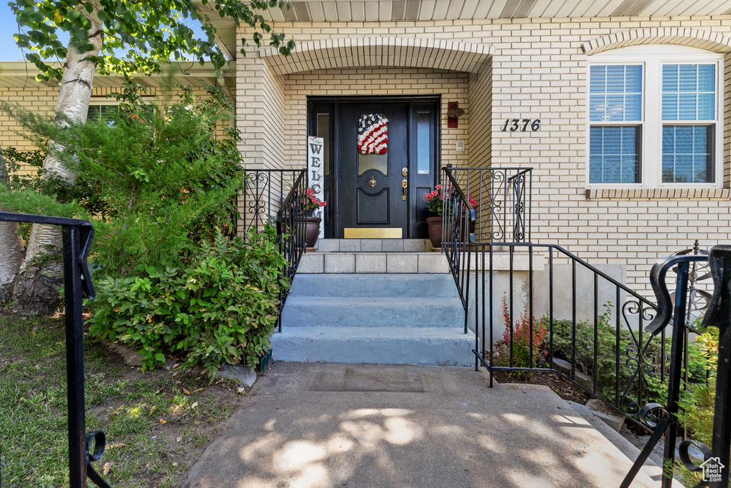 Entrance to property featuring brick siding