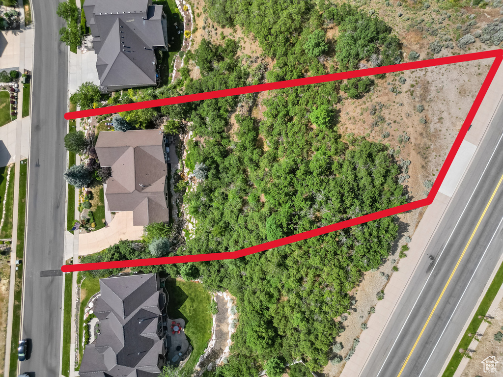 Aerial perspective of suburban area featuring property parcel outlined