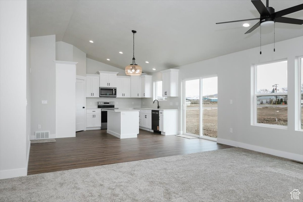 Kitchen with light countertops, visible vents, appliances with stainless steel finishes, a sink, and open floor plan