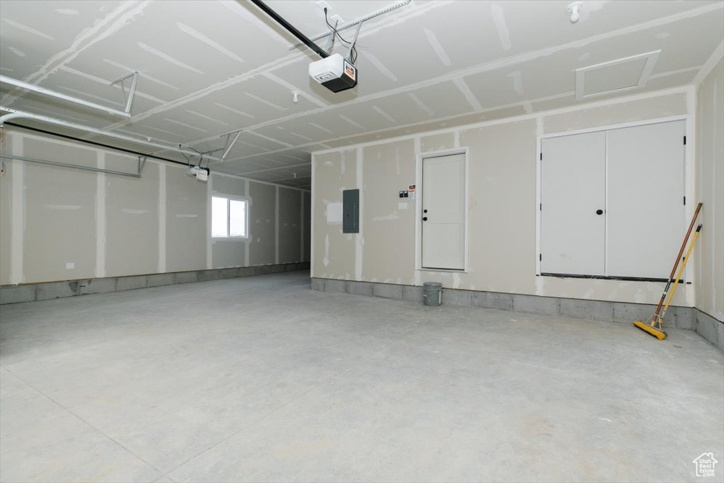 Garage with electric panel and a garage door opener