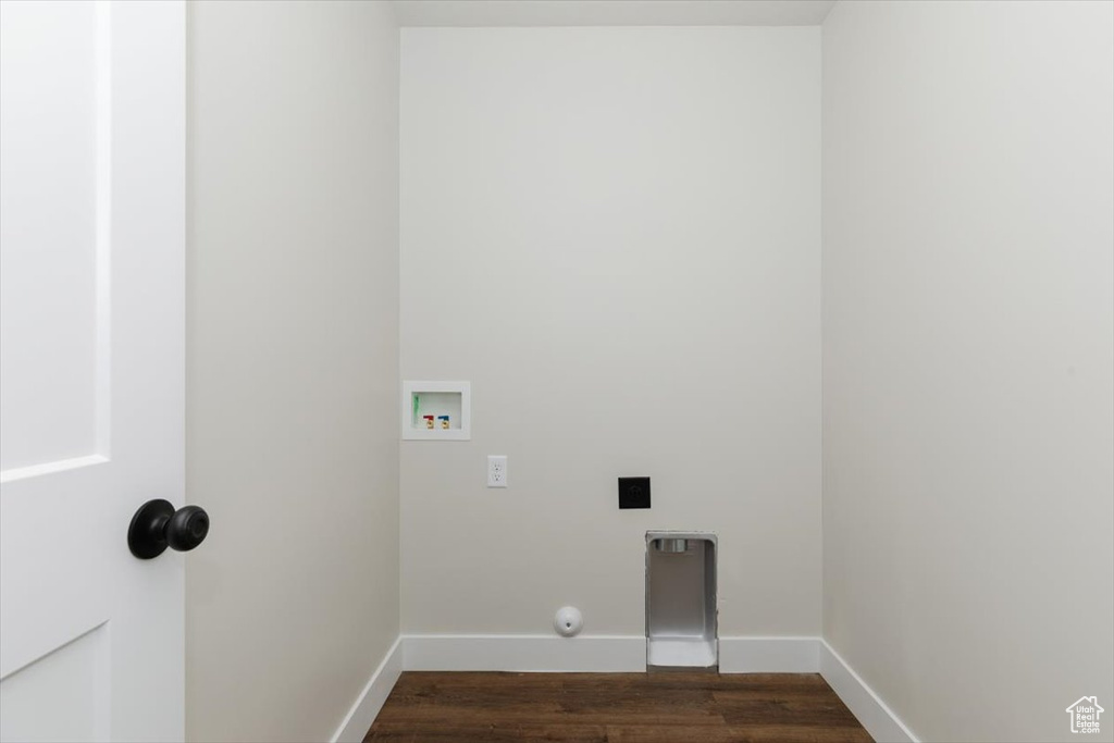 Laundry area with gas dryer hookup, baseboards, dark wood finished floors, laundry area, and washer hookup