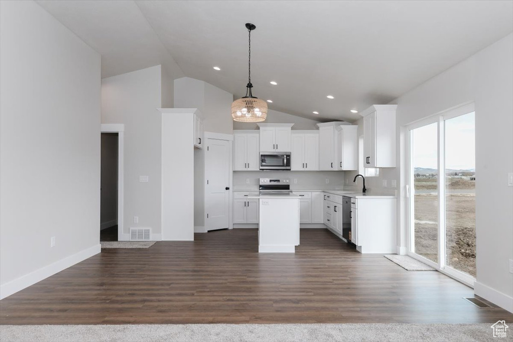 Kitchen with white cabinets, a sink, stainless steel appliances, and visible vents