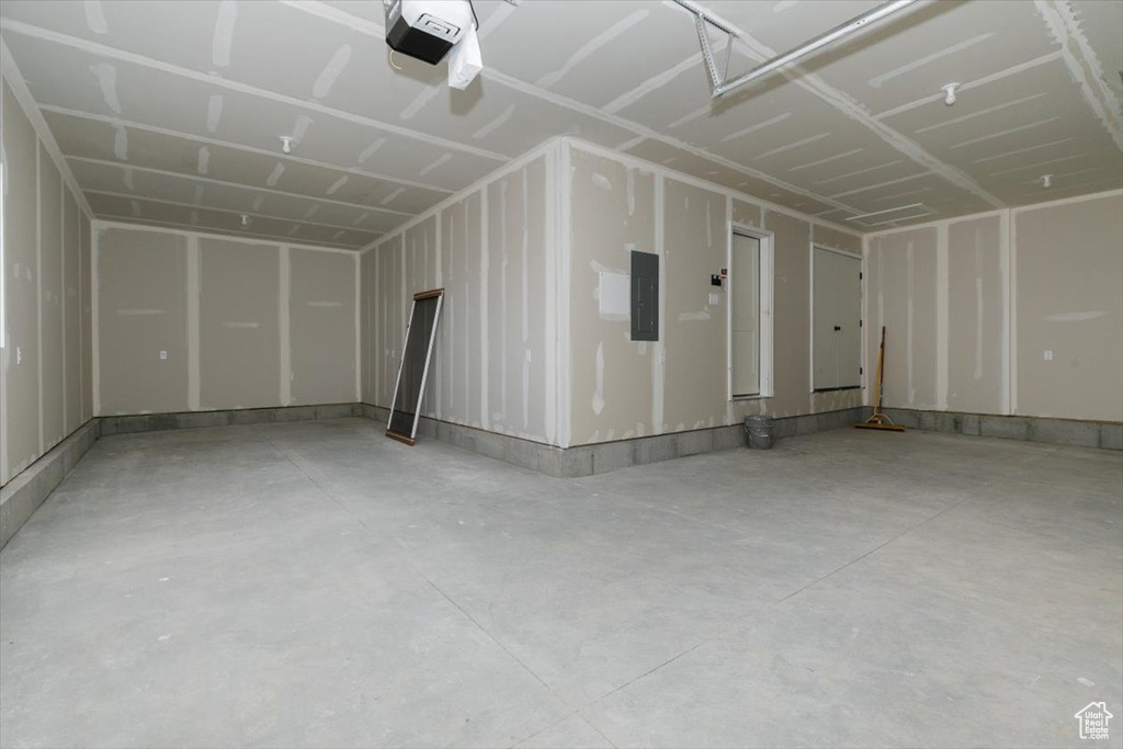 Garage with electric panel and a garage door opener
