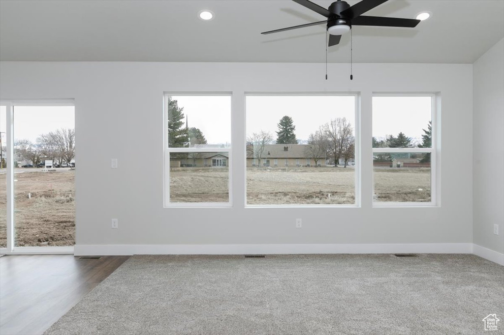Spare room featuring recessed lighting, baseboards, visible vents, a ceiling fan, and wood finished floors