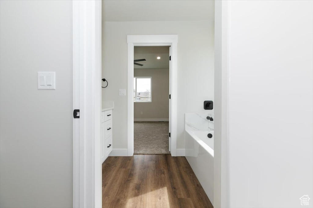 Corridor with baseboards and dark wood-type flooring