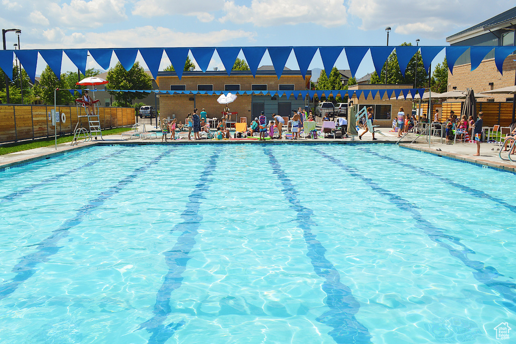Community pool with fence and a patio