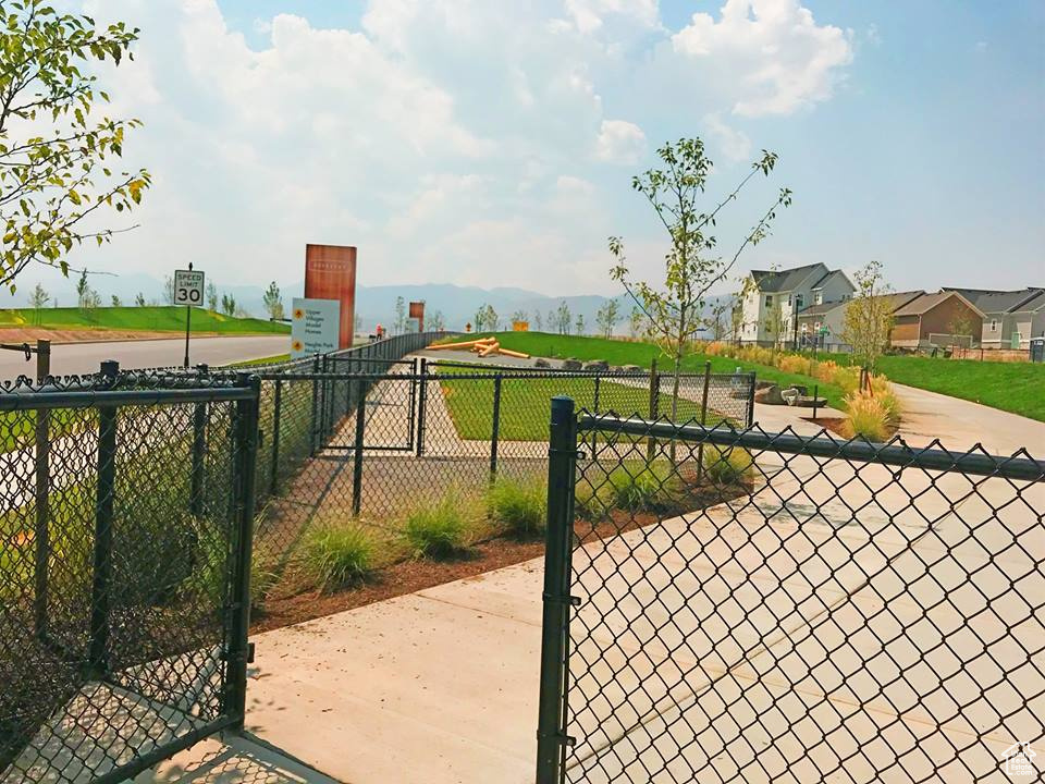 View of gate featuring fence