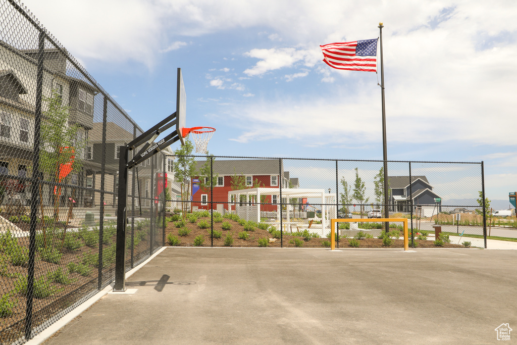 View of basketball court featuring community basketball court, a gate, and fence